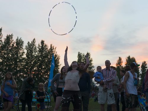 Brittany Roginson dances with her hula hoop at at Folk Fest on Thursday. She is performing in the fire shows Friday and Saturday at the festival at 1:00am. Sarah Taylor / Winnipeg Free Press July 10, 2014