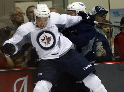 SPORTS - Fans at the Iceplex get an up close look at the hockey action when #72 Scott  Kosmachuk  puts hit on  #79 Shane Hanna . Winnipeg Jets Development Camp players  scrimmaged in front of a standing room  crowd at the MTS Iceplex   Story by Ed Tait . July 11 2014 / KEN GIGLIOTTI / WINNIPEG FREE PRESS