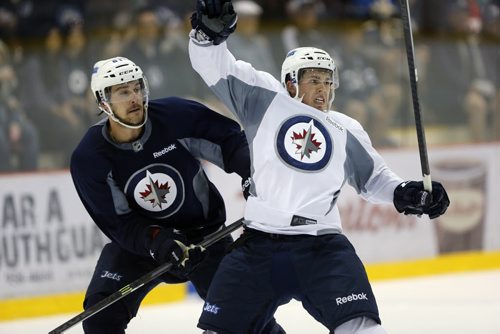 #72 right Scott Kosmachuk  takes hit from #61 Austen Brassard  .SPORTS - Winnipeg Jets Development Camp scrimmaged in front of a standing room  crowd at the MTS Iceplex   Story by Ed Tait . July 11 2014 / KEN GIGLIOTTI / WINNIPEG FREE PRESS
