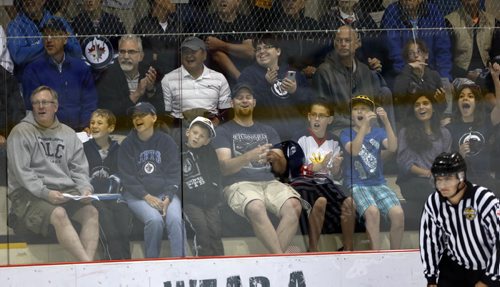 Jest fan in shots and tshirts enjoyed every minute of the scrimmage especially the goals .  .SPORTS - Winnipeg Jets Development Camp scrimmaged in front of a standing room  crowd at the MTS Iceplex   Story by Ed Tait . July 11 2014 / KEN GIGLIOTTI / WINNIPEG FREE PRESS