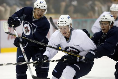 #47 Jack Glover gets between #92 Ralfs Freiderg  and Tucker Poolman .SPORTS - Winnipeg Jets Development Camp scrimmaged in front of a standing room  crowd at the MTS Iceplex   Story by Ed Tait . July 11 2014 / KEN GIGLIOTTI / WINNIPEG FREE PRESS