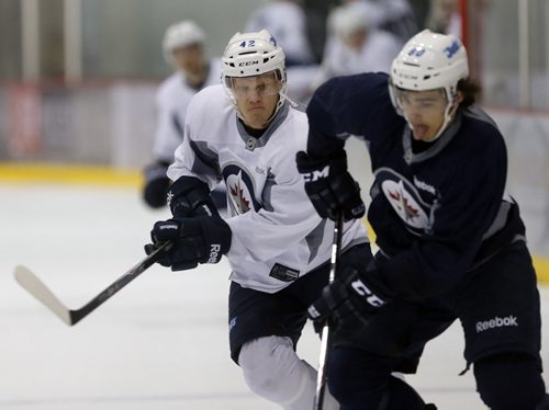 #42 Nikolaj  Ehlers checks #80 Joseph Blandisi .SPORTS - Winnipeg Jets Development Camp scrimmaged in front of a standing room  crowd at the MTS Iceplex   Story by Ed Tait . July 11 2014 / KEN GIGLIOTTI / WINNIPEG FREE PRESS