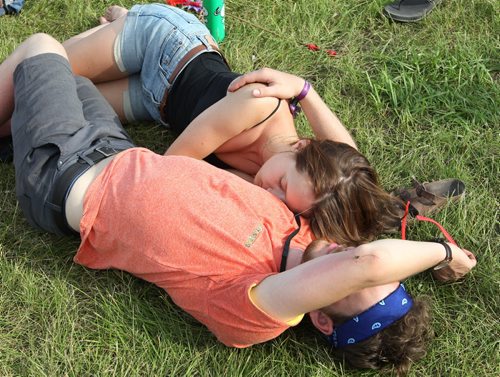 A young couple takes a break at the Winnipeg Folk Festival Main Stage friday night in Birds Hill Park-See Jen Zoratti story- July 11, 2014   (JOE BRYKSA / WINNIPEG FREE PRESS)