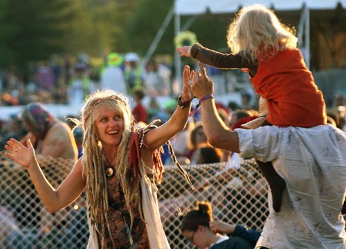Briar MacDonald goes for a ride on friend s  Marc Simard.s shoulders as mom Devaki MacDonald looks on at the  Winnipeg Folk Festival Main Stage friday night in Birds Hill Park during a beautiful summer evening-See Jen Zoratti story- July 11, 2014   (JOE BRYKSA / WINNIPEG FREE PRESS)