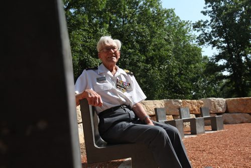 George Peterson, the last surviving member of the group of seven local Arden Ave war veterans from the Battle of Hong Kong, sits in one of the 7 chairs of honour  at the new Jules Mager Park in St. Vital where a special ribbon cutting ceremony was held Saturday morning. Minister Kevin Chief and St. Vital Councillor Brian Brian Mayes help Mr. Peterson out of his wheelchair and onto one of the seven chairs. See Ashley Prest story. July 12, 2014 Ruth Bonneville / Winnipeg Free Press