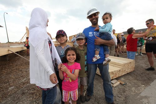Cycle of Hope raised $170,000 dollars for a  Habitat home that this family will be moving into.  Photo of the family that will be moving into the home that the Cycle for Hope members raised money for. Mohamed (dad) holds 16 month old Rahaf,  Rami in grey hat (8), Ranin in purple hat (10), Rawan in her pink shirt (6) with their mother on far left. Note: The last name of family is not provided to the media due to safety issues.  The mother chose not to use her first name or have her full face on camera.   See Ashley Prest Story.  July 12, 2014 Ruth Bonneville / Winnipeg Free Press