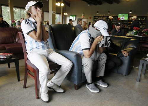 July 13, 2014 - 140713  -  Argentinian golfers Tommy Cochitake (L) and Gato Zarlenga react to the World Cup final after they finished their round at The Players Cup at Pine Ridge Sunday, July 13, 2014. John Woods / Winnipeg Free Press