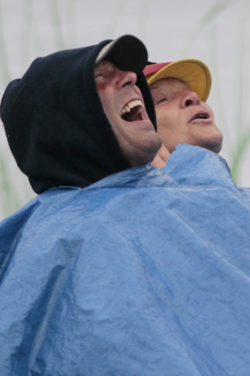 July 13, 2014 - 140713  -  Music fans Paul Dupuis and his sister in law make the best of a very wet final day of Folk Fest Sunday, July 13, 2014. John Woods / Winnipeg Free Press