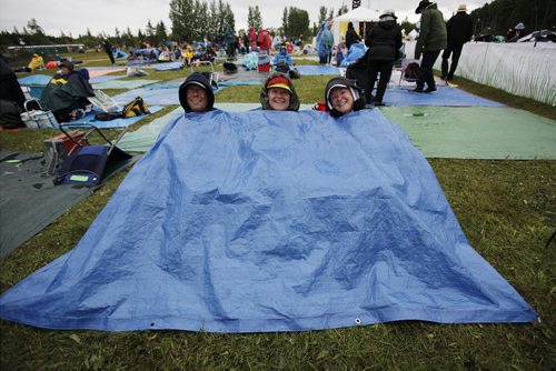 July 13, 2014 - 140713  -  Music fans Paul (L) and Carol Dupuis (R) and her sister (did not want to give name) cover up on a very wet final day of Folk Fest Sunday, July 13, 2014. John Woods / Winnipeg Free Press