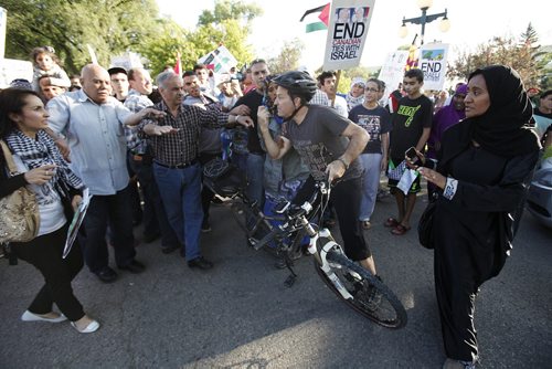 July 14, 2014 - 140714  -  An Israel supporter provokes peaceful Palestinian supporters by yelling "stop hiding behind your children" as they hold a rally at the Manitoba Legislature Monday, July 14, 2014. John Woods / Winnipeg Free Press