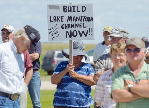 Twin Lakes Beach resident Lilli Schneider attends a gathering of farmers and residents to build a channel out of Lake Manitoba. Schneider has had to rebuild her home 80ft from where originally stood before the 2011 flooding. Sarah Taylor / Winnipeg Free Press July 15, 2014