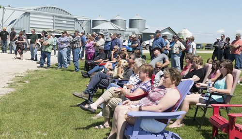 Residents and farmers gather to build a channel out of Lake Manitoba to prevent damage to their land on Tuesday at Mark Peters' farm north of Portage la Prairie. Sarah Taylor / Winnipeg Free Press July 15, 2014