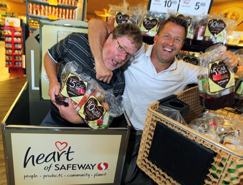 LOCAL - DOUG COULUM -  Doug Speirs and Doug Brown make the first official donation for the Safeway Food Drive of $5 and $10 at Linden Ridge Safeway. Safeway food bank hamper packages and the Harvest bin located at Safeways throughout the city. BORIS MINKEVICH / WINNIPEG FREE PRESS  July 15, 2014