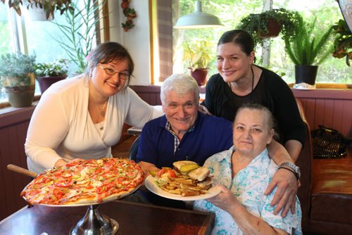 Loona Rossa Restaurant Review  The Cravariotis family in their restaurant with two of the hot sellers - Their clubhouse platter and the Loona Rossa Special (Pizza).   Dimitrios and his wife Catina with their daughters Nia (white) and Tina (black).  July 15, 2014 Ruth Bonneville / Winnipeg Free Press