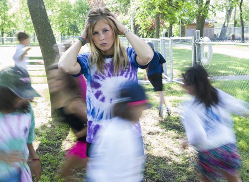 140716 Winnipeg - DAVID LIPNOWSKI / WINNIPEG FREE PRESS  Cara Gulay works at Seven Oaks coordinating a kids camp called MYCamp. She is photographed with kids running around her.  For Tim Shantz 49.8 article, as she is in the story as someone who gets bad headaches.