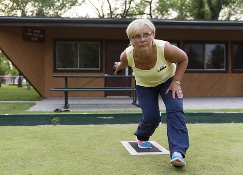 Nadine Horsman plays lawn bowling at St. John's park on Wednesday evening. Sarah Taylor / Winnipeg Free Press July 16, 2014