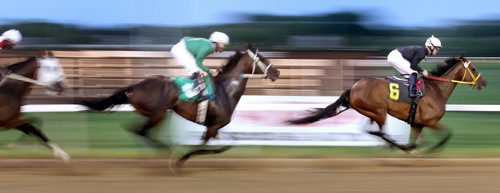 Balooga Bull (Paul M Nolan riding) leads a blurr of  at Assiniboia Downs Wednesday evening in the 7th Race, the team went on the win "The Wheat City" event a primer for the Manitoba Derby. See story. July 16, 2014 - (Phil Hossack / Winnipeg Free Press)