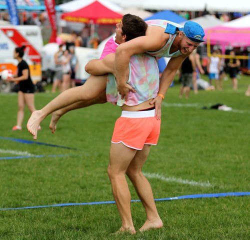 Two members of Poppin Volley's celebrate a point at the Super-Spike volleyball tournament at Maple Grove Rugby Park, Friday, July 18, 2014. (TREVOR HAGAN/WINNIPEG FREE PRESS)