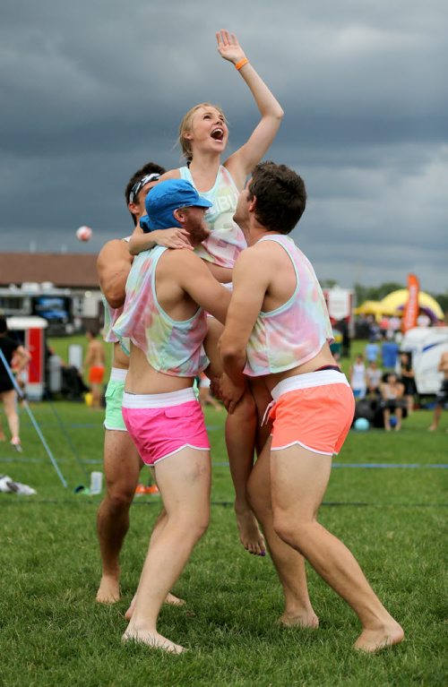 Three members of Poppin Volley's celebrate a point, hoisting Andrea Malcolm into the air, at the Super-Spike volleyball tournament at Maple Grove Rugby Park, Friday, July 18, 2014. (TREVOR HAGAN/WINNIPEG FREE PRESS)