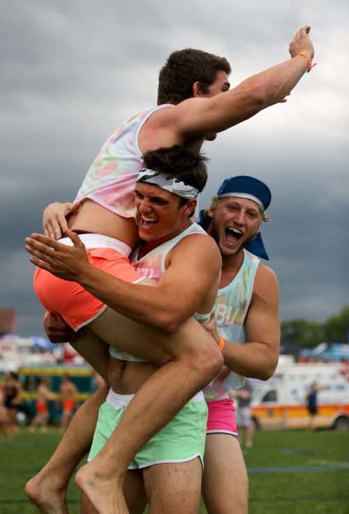 Three members of Poppin Volley's celebrate a point at the Super-Spike volleyball tournament at Maple Grove Rugby Park, Friday, July 18, 2014. (TREVOR HAGAN/WINNIPEG FREE PRESS)