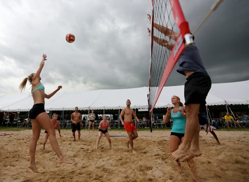 The City Kitties, left, versus Team Whiskey Dix at the Super-Spike volleyball tournament at Maple Grove Rugby Park, Friday, July 18, 2014. (TREVOR HAGAN/WINNIPEG FREE PRESS)