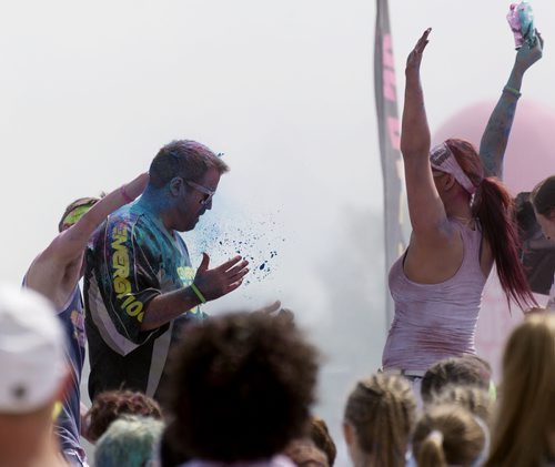 Energy 106 radio host Jd Francis gets sprayed on stage at Colour Me Rad on Saturday at Assiniboia Downs. Sarah Taylor / Winnipeg Free Press July 19, 2014