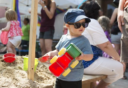 Samuel Mahe, 22 months, plays in the sand pit at Fringe Fest on Saturday. Sarah Taylor / Winnipeg Free Press July 19, 2014
