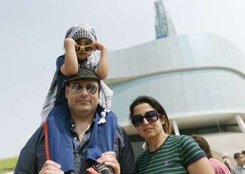 Hussam Azzam, his wife Orhan Khalil-Azzam and their son A.K. Azzam attend the rally for Gaza on Saturday. Sarah Taylor / Winnipeg Free Press - Jessica BU story for more info on family. July 19, 2014
