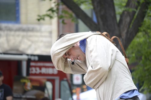 DSC_1831 - Chris Visser escapes out of a straightjacket at Old Market Square on July 18, 2014. Though he only makes money from what people donate, Visser says not paying for a venue makes up for that. Oliver Sachgau / Winnipeg Free Press