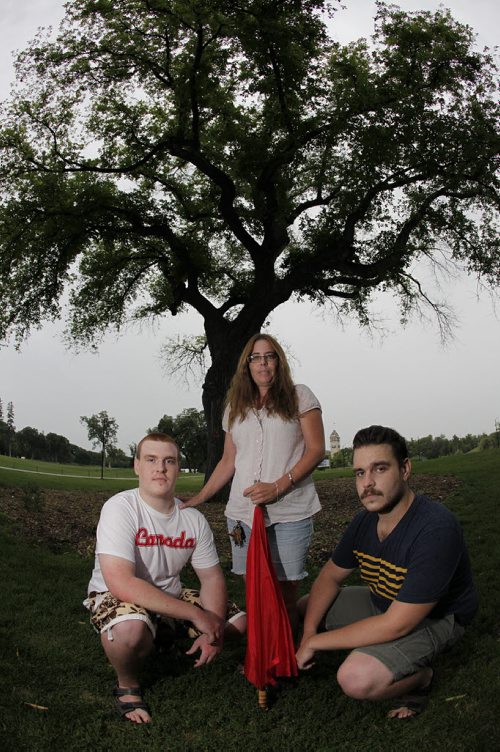 July 21, 2014 - 140721  -  Brothers Cory (L) and Ryan Buchanan with Carol Scimming in front of the "Grandma Tree"Monday, July 21, 2014. The tree is scheduled to be cut down due to Dutch Elm Disease. John Woods / Winnipeg Free Press