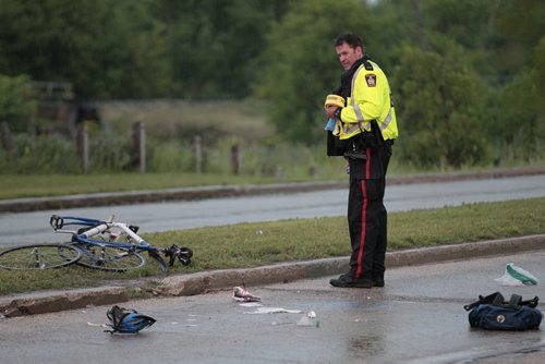 July 21, 2014 - 140721  -  Police investigate a cyclist and car collision on Empress Street East Monday, July 21, 2014.  John Woods / Winnipeg Free Press