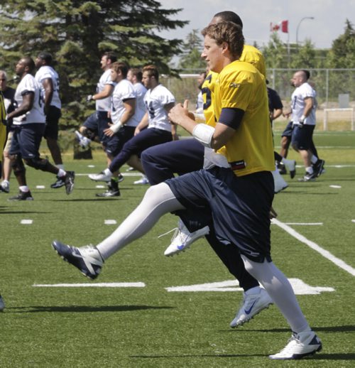 Winnipeg Blue Bombers QB Drew Willy and team mates warm up during the team's practice at Bison field Tuesday. The Blue Bombers next game is Friday night in B.C. against the Lions. Ed Tait story. Wayne Glowacki / Winnipeg Free Press July 22 2014