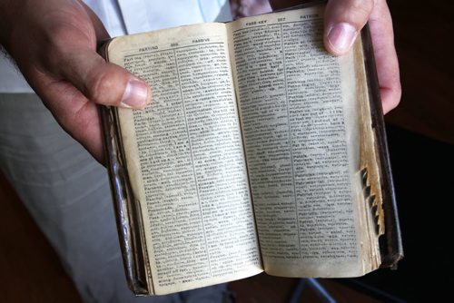 Recent Greek immigrant Stefanos Boukis shows Greek/English translation book his great grandfather used when he came to New York city many years ago -See Carol Sanders Story- July 22, 2014   (JOE BRYKSA / WINNIPEG FREE PRESS) ( Eds Tyler is preparing a small Blippar video of one of their recent concerts)