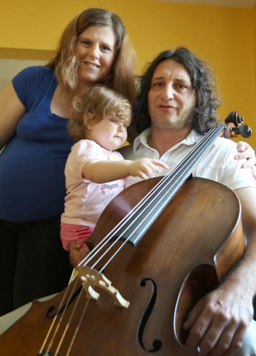 Recent Greek immigrants Stefanos Boukis, his wife Lia Andronikou and their daughter Danai Bouki with their fathers antique cello in their West end home -See Carol Sanders Story- July 22, 2014   (JOE BRYKSA / WINNIPEG FREE PRESS) ( Eds Tyler is preparing a small Blippar video of one of their recent concerts)