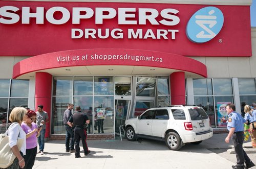 An SUV drove through the front doors of a Shoppers Drug Mart at Leila and McPhillips around 2:45pm Wednesday. No one was seriously injured. The store is currently closed. 140723 - Wednesday, July 23, 2014 - (Melissa Tait / Winnipeg Free Press)