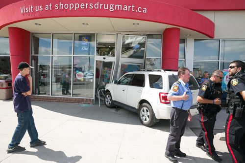 An SUV drove through the front doors of a Shoppers Drug Mart at Leila and McPhillips around 2:45pm Wednesday. No one was seriously injured. The store is currently closed. 140723 - Wednesday, July 23, 2014 - (Melissa Tait / Winnipeg Free Press)