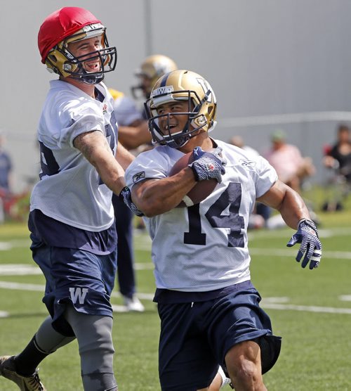 NICE HAT , #14 SB , Aaron Woods takes pass  and run with a smile during scout team drill . Wpg Blue Bomber prepare for Friday's game in Vancouver vs the BC Lions  July 23 2014 / KEN GIGLIOTTI / WINNIPEG FREE PRESS