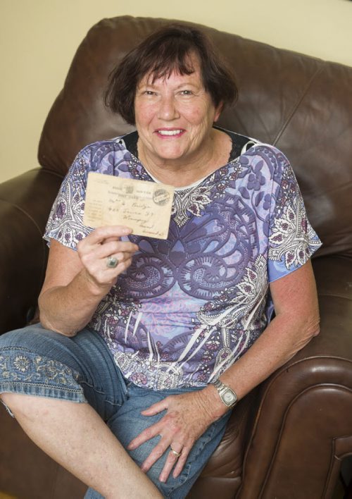 140723 Winnipeg - DAVID LIPNOWSKI / WINNIPEG FREE PRESS  Allison Bridge has a card that her grandfather sent to her grandmother (his wife) confirming that he was now a prisoner of war. She shows the card, and photo at her home Wednesday July 23, 2014.