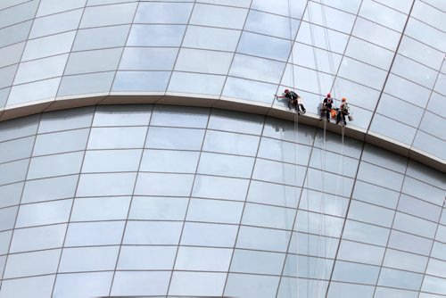 Jonathan Burridge, Chris Tonn and Kyle Dufont, from left, clean the windows on the outside of the Canadian Museum for Human Rights in Winnipeg Thursday morning. - July 24, 2014   (JOE BRYKSA / WINNIPEG FREE PRESS)