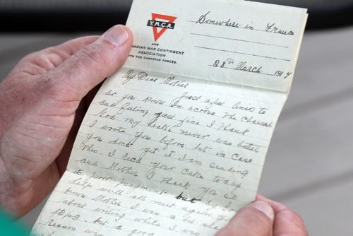 Bill Anderson  with a letter sent home-part of his  grandfathers WW 1 memorabilia - See Kevin Rollason story Story- July 24, 2014   (JOE BRYKSA / WINNIPEG FREE PRESS)