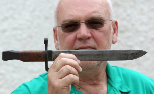 Bill Anderson  with his bayonet for a Ross rifle part of his  grandfathers WW 1 memorabilia - See Kevin Rollason story Story- July 24, 2014   (JOE BRYKSA / WINNIPEG FREE PRESS)