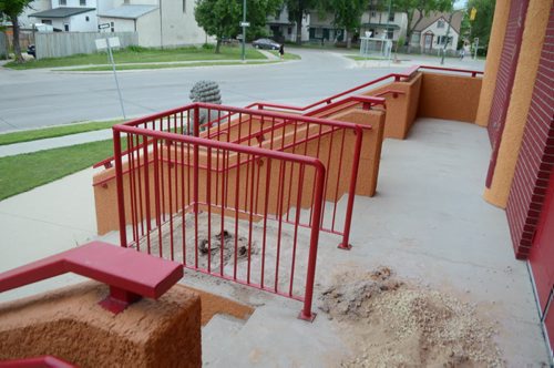 Sand and ashes are scattered at the entrance of the Huasing Buddhist Temple on Cumberland Avnue after the urn that usually adorns the entrance was stolen late Monday night. July 24, 2014. (Oliver Sachgau/ Winnipeg Free Press)