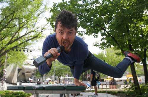 Ross Vegas, star of the Fringe play Running on Stilts, in a hand stand stall at Old Market Square on Friday.  (Doug Speirs weather video) 140725 - Friday, July 25, 2014 - (Melissa Tait / Winnipeg Free Press)
