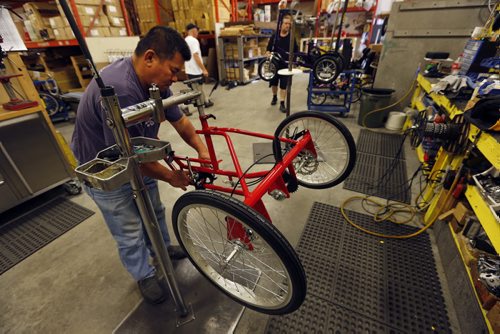 In pic Tony Capucion  works on custom bike for a special needs customer . LOCAL FEATURE  Ken Vanstraelen, president of Freedom Concepts (not in photo)  ¬Freedom Concepts make bicycles for special needs children and people with disabilities. Doing a profile on the company.  Adam Wazny City Reporter July 25 2014 / KEN GIGLIOTTI / WINNIPEG FREE PRESS