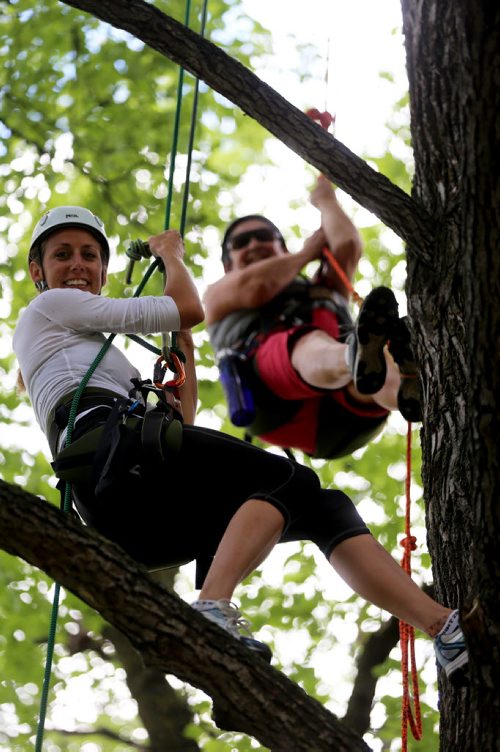 Lori Fast, left, with Travel Roots, a Winnipeg adventure company that offers tree climbing excursions around the city, Saturday, July 26, 2014. (TREVOR HAGAN/WINNIPEG FREE PRESS) - for Dave Sanderson 49.8 piece.