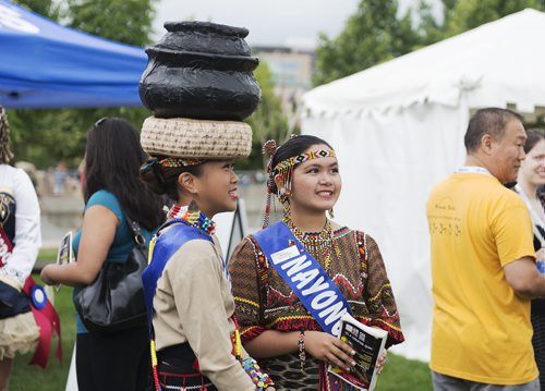 Hanna Uy (left) and May Jamora from Nayong Pilipano Pavilion get excited for Folklorama at it's kick at the Forks on Saturday. The festival starts August 3. Sarah Taylor / Winnipeg Free Press July 26, 2014