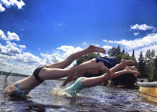 (Front or back) Risa Shatford, Nadia Minkevich, and Wayne Shatford head into the lake to cool off this weekend. The weekend dock divers enjoyed the Lake of the Woods where water levels are still super high. BORIS MINKEVICH / WINNIPEG FREE PRESS¤¤July 27, 2014