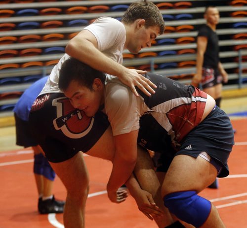Bottom , Kyle Nguyen UofW men's captain  lifts Fin Higgins   a recruit from the USA .(not in photo is Sports . Russian Olympic Wrestler Sergei Belogazov puts on wrestling camp .July 28 2014 / KEN GIGLIOTTI / WINNIPEG FREE PRESS