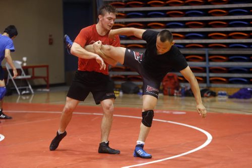 Sports . Wrestler (left)  Jacob Luczak  works out wresling moves with Alexander Sofronoo recruited from Siberia . (not in photo is  Russian Olympic Wrestler Sergei Belogazov puts on wrestling camp .July 28 2014 / KEN GIGLIOTTI / WINNIPEG FREE PRESS