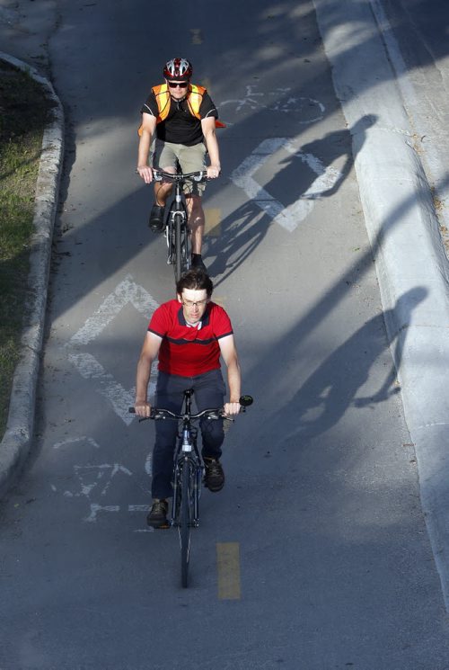 Stdup . Great start for the day expect sun and highs of of + 26 . Cyclists  on Assiniboine Ave at Donald St on a cool morning ride . July 29 2014 / KEN GIGLIOTTI / WINNIPEG FREE PRESS